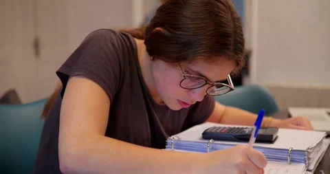 A young student is immersed in her studies. Stock Footage 334776552