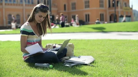 Young student with laptop computer on campus, steadicam shot HD Stock Footage 12132819