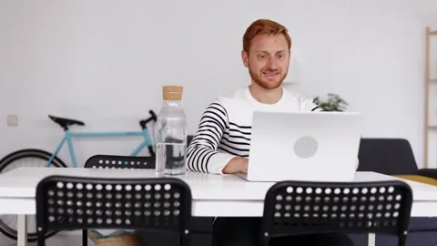 Young student man working on laptop computer sitting on table at home Stock Footage 282404450