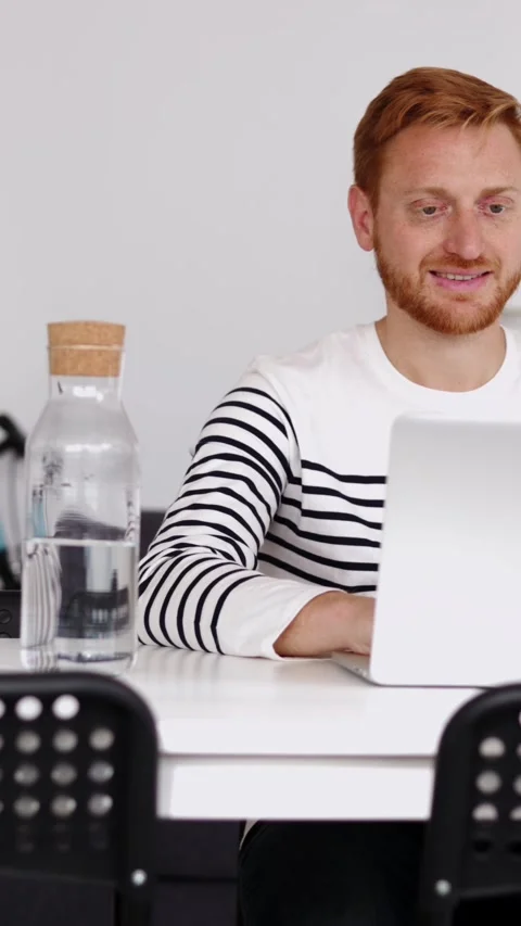 Young student man working on laptop computer sitting on table at home Stock Footage 312198752