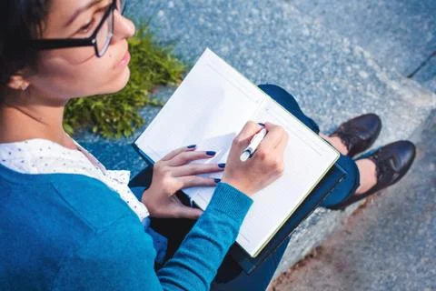 Young student with notebook. Online studying outdoors consept Stock Photos