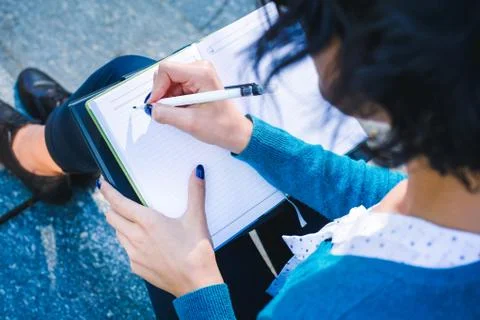 Young student with notebook. Online studying outdoors consept Stock Photos