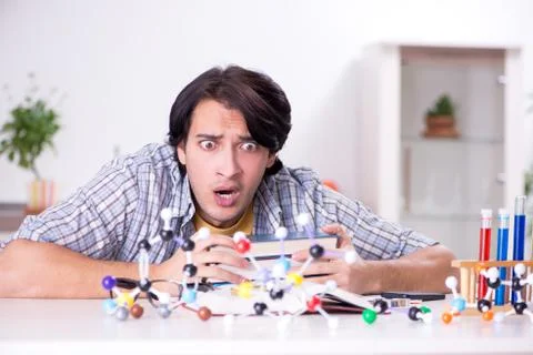 Young student physicist preparing for exam at home Fotos Stock