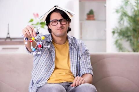 Young student physicist preparing for exam at home Stock Photos
