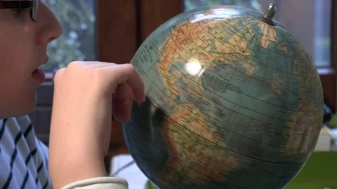 Young student pointing on globe for geography class Stock Footage 86263841