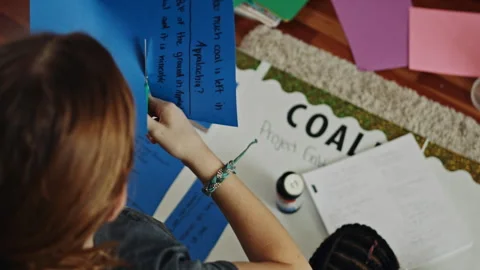 Young student preparing a coal project for a school science fair Video stock 334097436