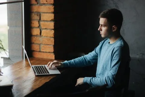 Young student programmer work at the cafe. He prepare for lesson Stock-Fotos