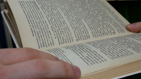 Young student reading a book in the library Stock Footage 86565687