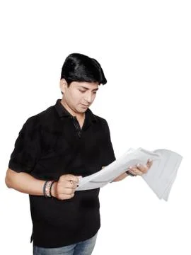 Young student reading notes before exam. Stock Photos