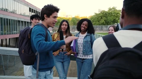 Young student reporter interviewing a peer on campus Stock Footage 329910182