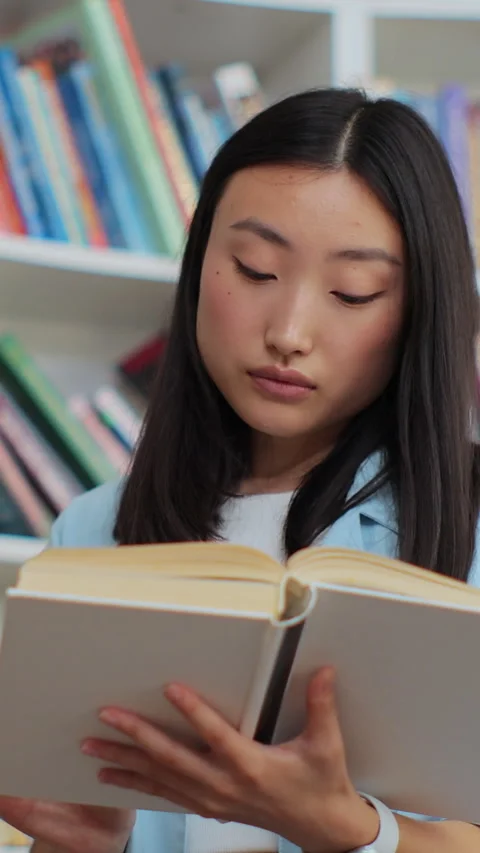 Young student researching in library for self-education. Stock Footage 345146777