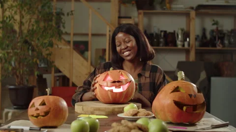 A young student is sitting at a festive table. She joyfully examines the Stock Footage 163254905