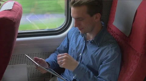 Young student sitting on the train and using a tablet Stockbeeldmateriaal 51832707