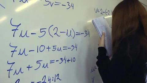 Young student solving a math problem on a whiteboard Stockbeeldmateriaal 345189158