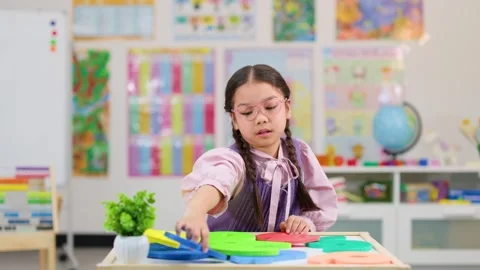 Young Student Solving Math Puzzle in Classroom Setting Stock Footage 329612117