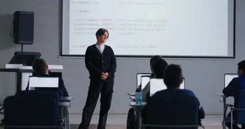 Young Student Speaking In Front Classmates In Computer-Based Classroom, Display Stock Footage 281613655