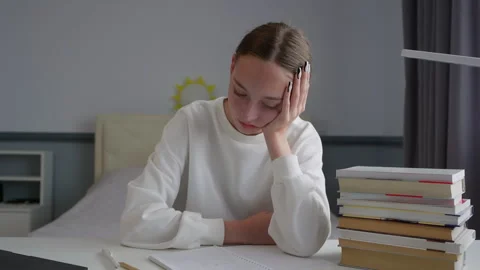 Young student struggling with studies, feeling bored and tired Stock Footage 315174499