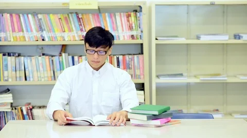 Young student study hard in library. Stock Footage 85653138