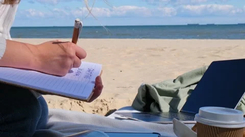 Young student study with notebook on beach next to sea ocean view. Writing Stock Footage 220534661