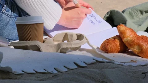 Young student study with notebook on beach next to sea ocean view. Writing Stock Footage 220534698