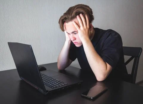 A young student is studying distance learning at home. Stock Photos