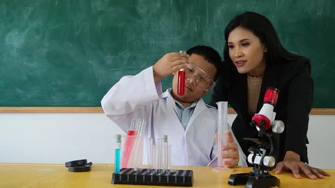 Young student studying with his teacher Stock Footage 90273003