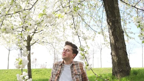 Young student studying the topic with a laptop in the spring garden Stock-Footage 78605388