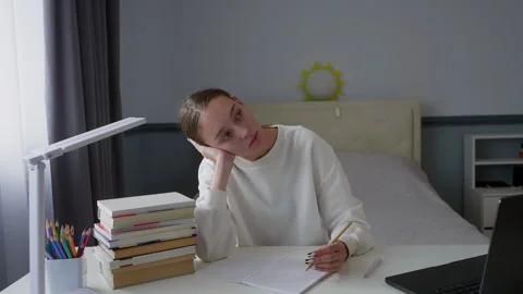 Young student taking a break from studying, thinking about something Stock Footage 315174015