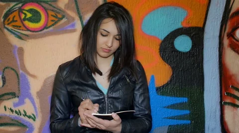 Young student taking notes near a murals Video stock 51416515