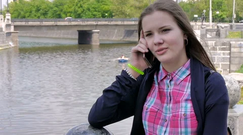 Young Student Talking On A Cell Phone At The River. Stock Footage 62773855