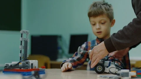 Young student with teacher working with robots. Stock Footage 92948198