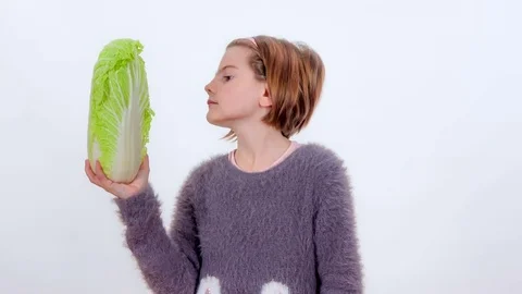 Young student is trying a radicchio Stock Footage 83724576