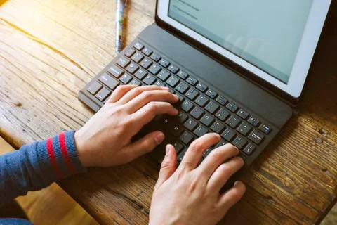 Young student types on a computer during home school while quarantined - Pand Stock Photos