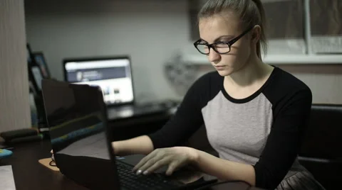 Young student typing on laptop text at night Video stock 60051917