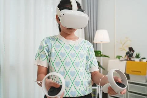 A young student uses a VR headset for interactive lesson, transforming educ.. Stock Photos