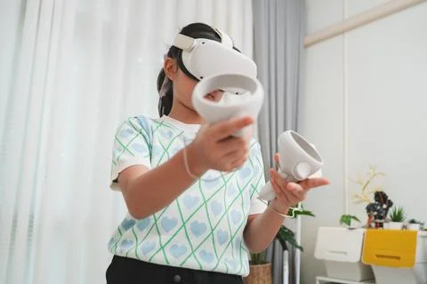 Young student uses VR headset for interactive lesson, transforming education. Stock Photos