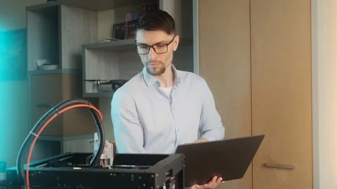 Young student using a 3D printer in college Stock Footage 236616053
