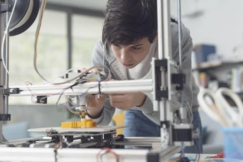 Young student using a 3D printer Stock Photos