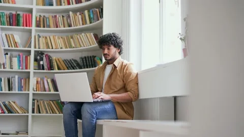 Young student using laptop computer to type for online e-learning in campus  Stock Footage 239734276