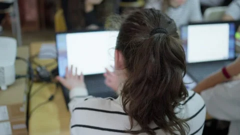 Young student using a laptop computer during a classroom lesson in a modern.. Video stock 347162994