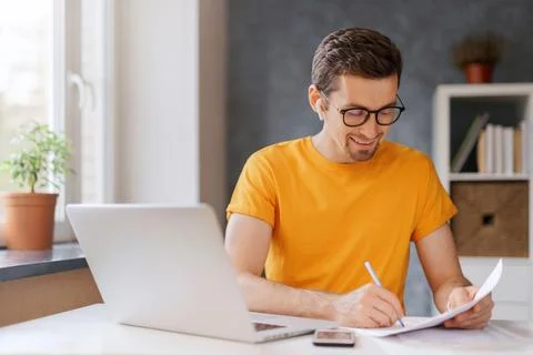 Young student using laptop for e-learning at home Stock Photos