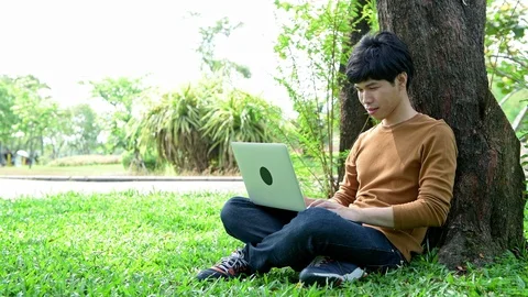 Young student using laptop in park. Stock Footage 92291137