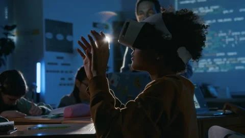 Young Student in VR Headset Manipulating Objects in Metaverse in Coding Class Stock Footage 307065748