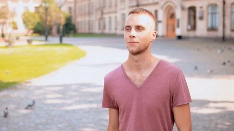 Young student walks in campus area Stock Footage 99864857