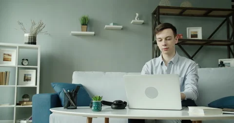 A young student is working with headphones at the computer and listening to fun Video stock 130502417