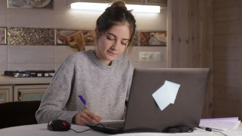 Young student write in notebook and work on laptop 動画素材 129008954