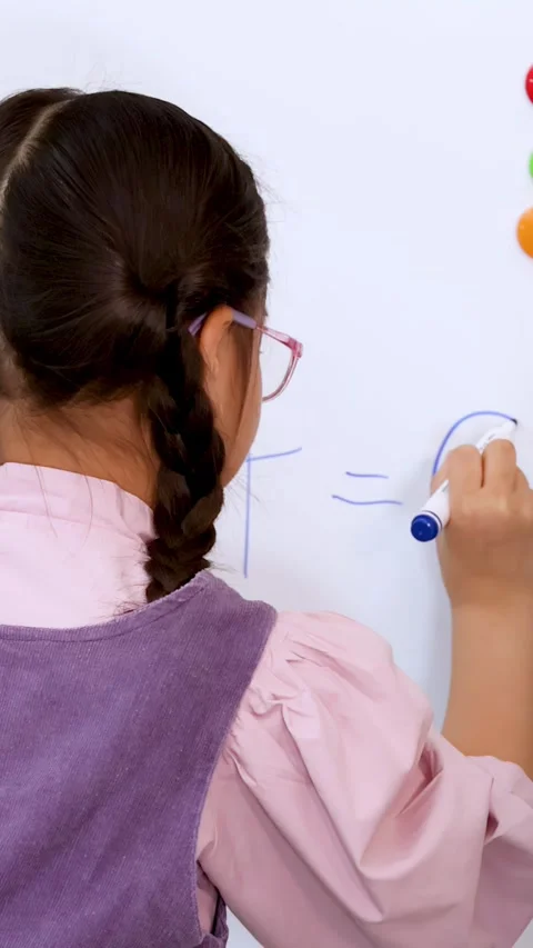 Young Student Writing Math Equation Answer on Whiteboard in Classroom Stock Footage 326589887