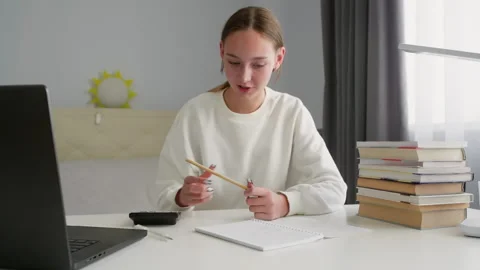 Young student writing notes and learning online Stock Footage 315175177