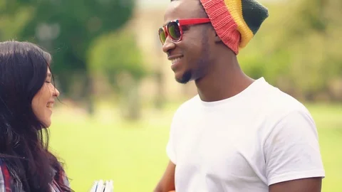 Young students afroamerican guy and girl talk nicely between classes outdoors Video stock 126284598