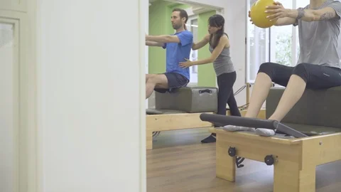 Young students and instructor working the upper body with a wunda chair. Stock Footage 126974710